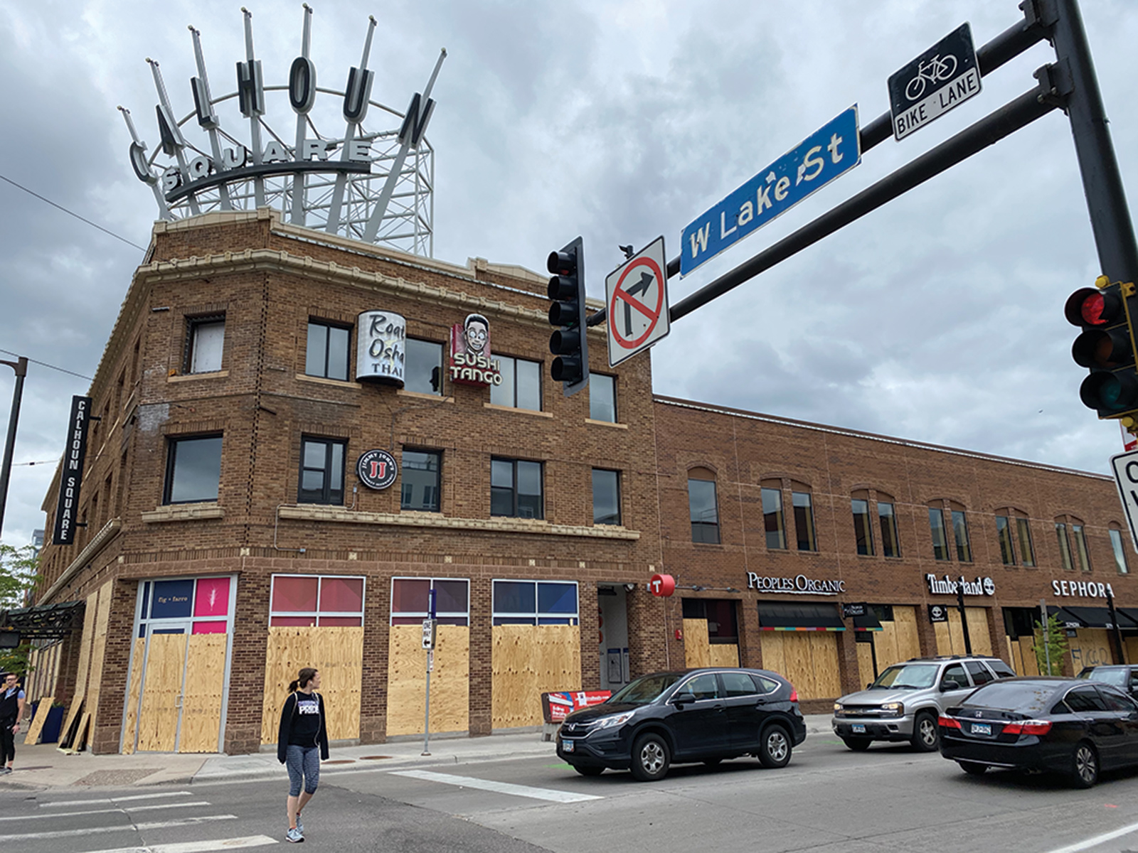 The intersection of Lake Street and Hennepin Avenue in Uptown with boards on windows of buildings