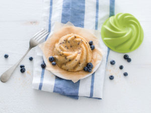 a small cake with blueberries on it