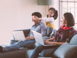 Family of three with laptops