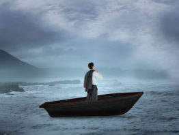man in a suit in a small boat in a storm