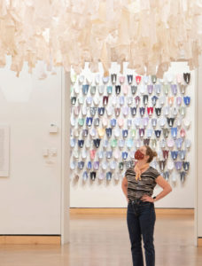 woman standing in art exibit