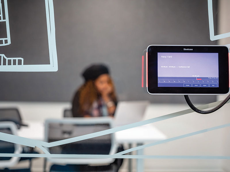 person working in a glass walled office