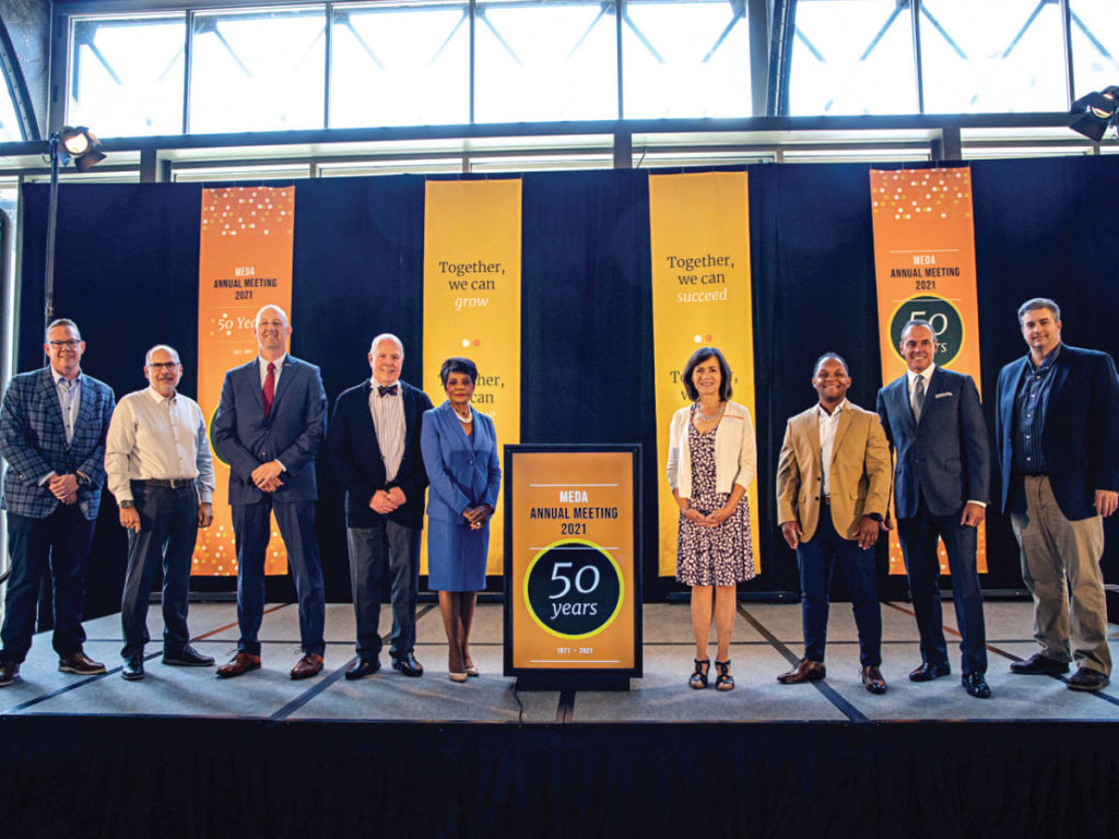 group of MEDA board members on a stage