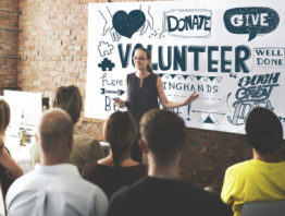 Women leading a volunteer meeting