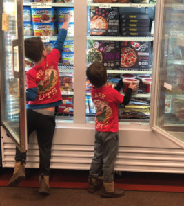 All in the family: Tommy Burt’s kids restock shelves.