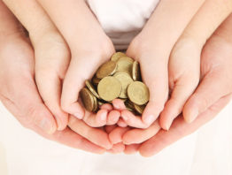 cupped hands holding coins