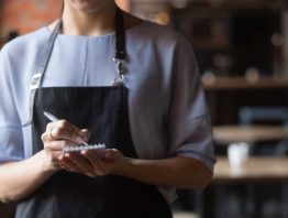 restaurant server with a pen and paper