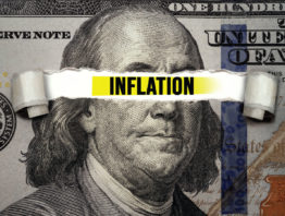 one hundred dollar bill with the word inflation over Ben Franklin's eyes