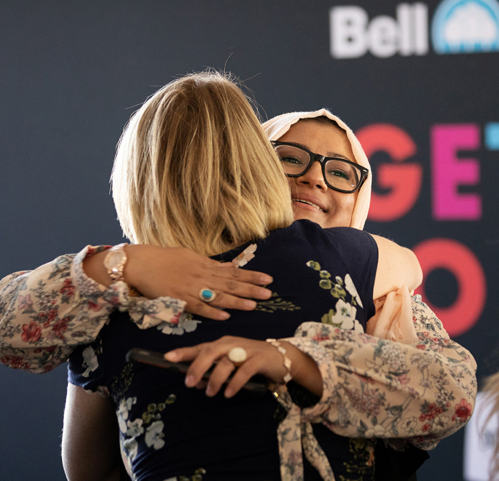 Finalist Annie Qaiser gives a hug during the Get Down to Business Accelerator in Blaine, Minnesota