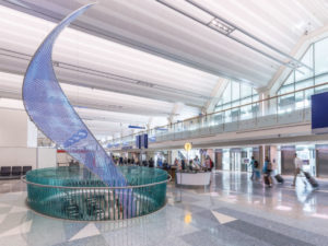 The Aurora sculpture, with T1's iconic folded-plate roof above.