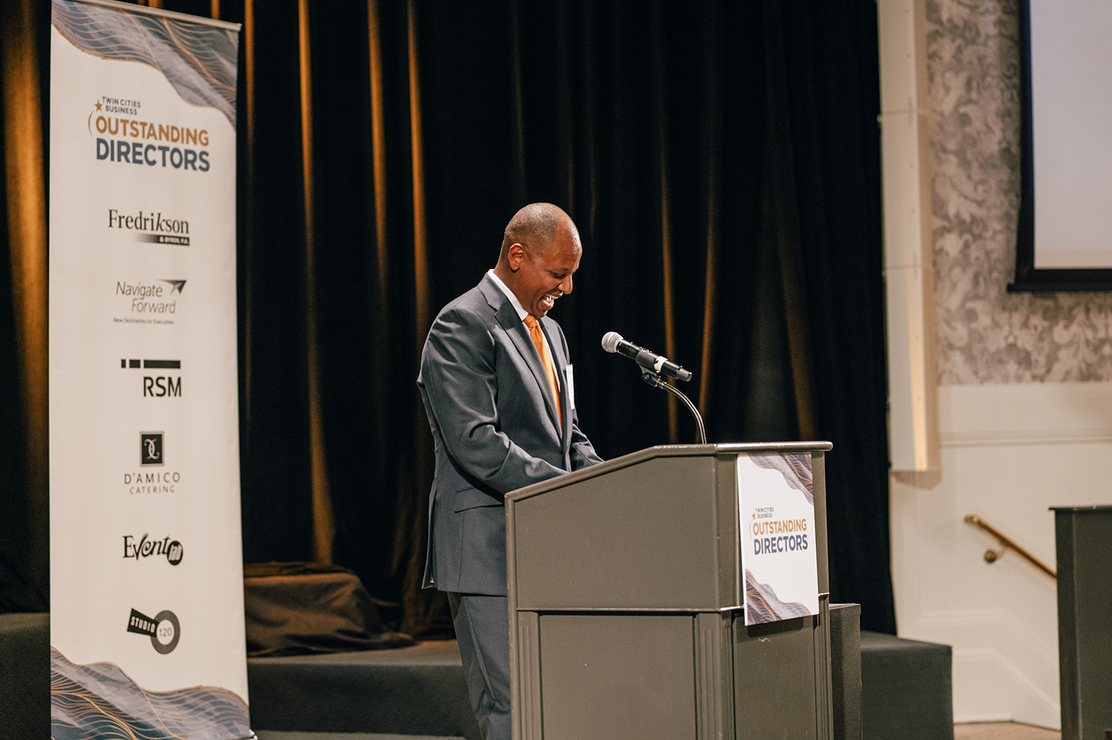 Teddy Bekele accepting a 2022 Outstanding Director award at the Metropolitan Ballroom in Minnesota