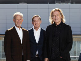 Jim, Bob, and Bill Pohlad on a windy RBC Gateway tower rooftop