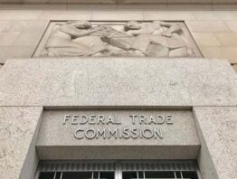 Federal Trade Commission headquarters building entrance with sign above door and exterior.