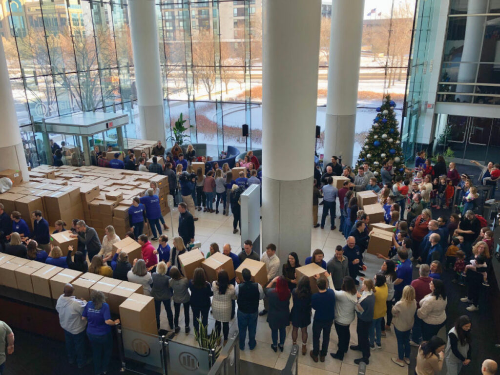 large room of people loading boxes for charity