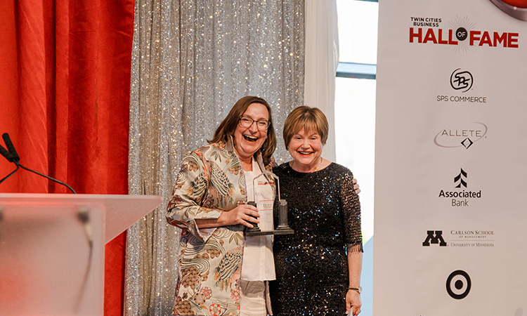 Sara Stern and Kari Rihm pose on stage.