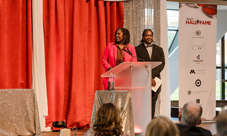 Northside Achievement Zone president and CEO Sondra Samuels and mentee Marcus Hunter introduce Target's Laysha Ward.