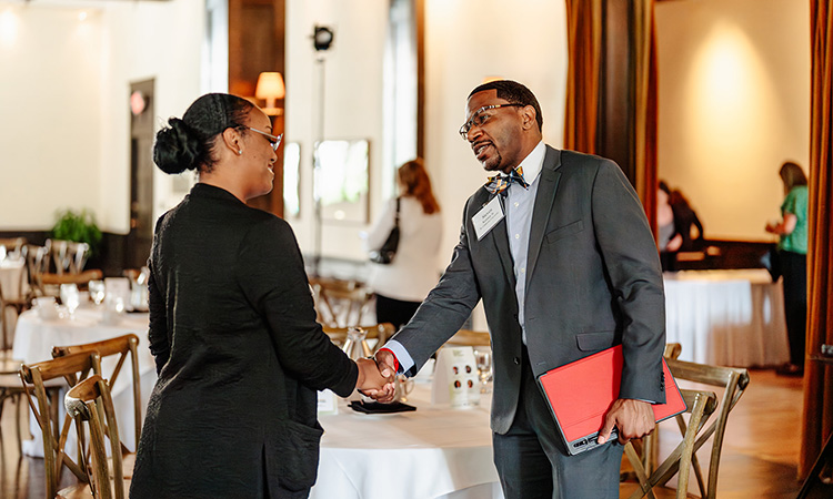 Attendees shake hands at TCB Talks: Diversity, Equity, and Inclusion on June 15, 2023