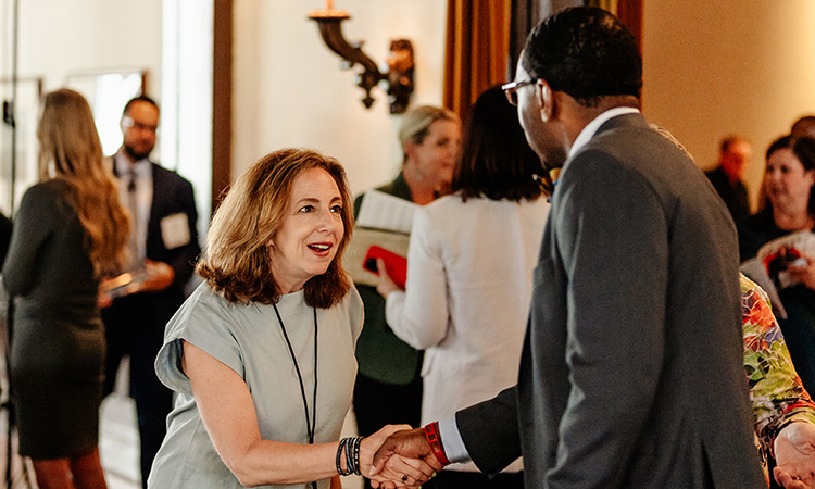 TCB editor-in-chief Allison Kaplan shakes hands with an attendee on June 15, 2023