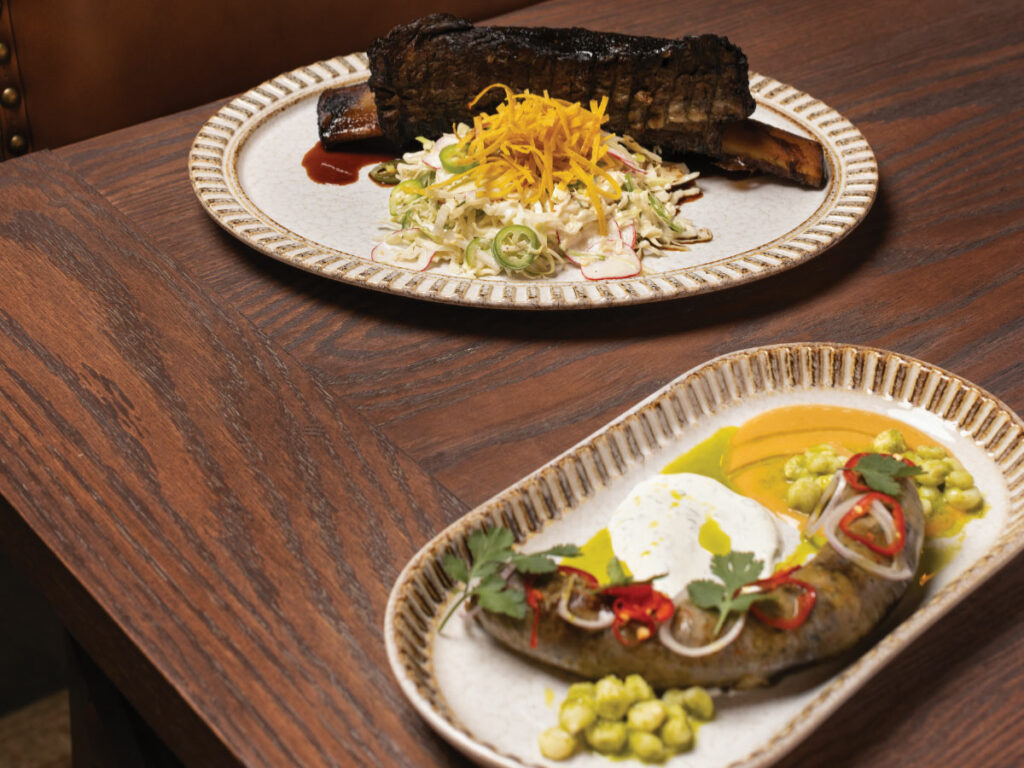 The long rib with tortilla slaw (top) and green chorizo sausage with tortilla gravy at Butcher & the Boar
