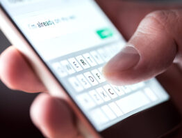 Close-up shot of a person sending a text on a smartphone