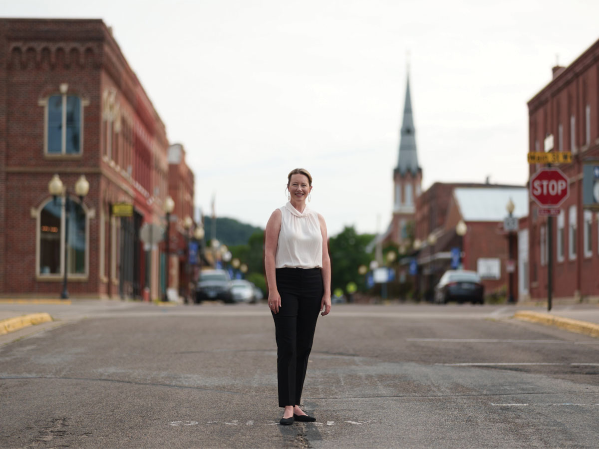Emily Durand stands in a small town street