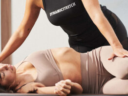 A Life Time employee performing a "Dynamic Stretch" session with a member.