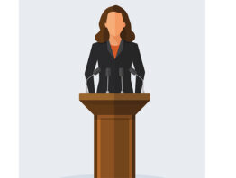 Politician woman standing behind rostrum and giving a speech.