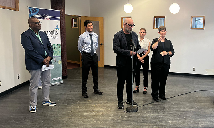 Ben Johnson (at mic), director of the city's arts and cultural affairs department, is flanked by Jeff Swinton, Jacob Frey, and Katie Cashman
