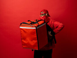 Delivery man against a red background