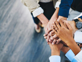 group of diverse businesspeople putting their hands on top of one another's