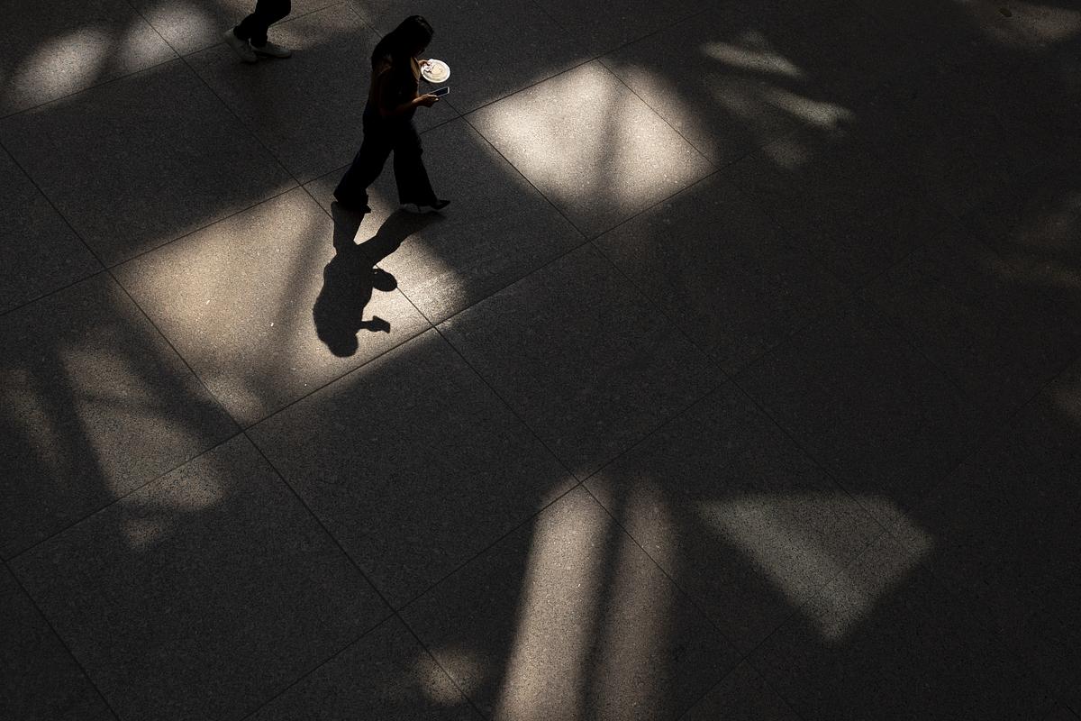 A worker walks through the IDS Center, an office tower at the center of the skyway system, with her lunch on Monday, Sept. 8, 2025, in downtown Minneapolis