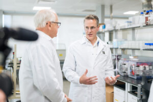 Gov. Tim Walz and Nucleus RadioPharma CSO Dr. Geoff Johnson in a lab.
