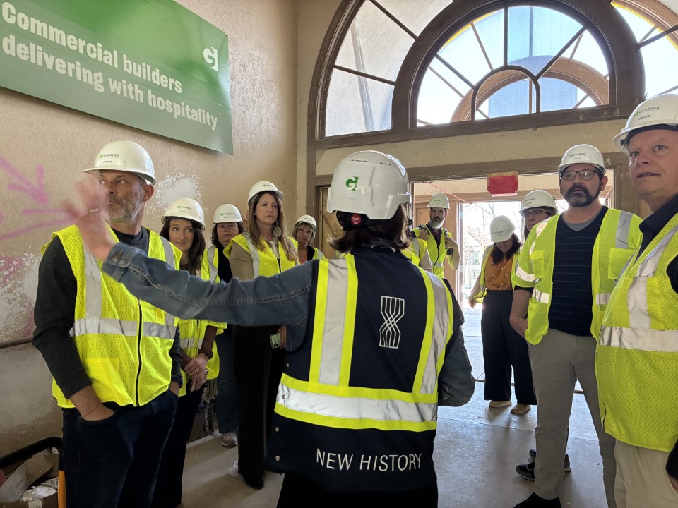 Meghan Elliott leads a tour of the inside of The Bookmatch building before it was renovated